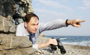 Businessman Searching Under Rock